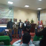 Law Student with Professor Nigusie hold cup group photo Law Student with Professor Nigusie hold cup group photo