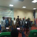 Law Student with Professor Nigusie hold cup group photo Law Student with Professor Nigusie hold cup group photo